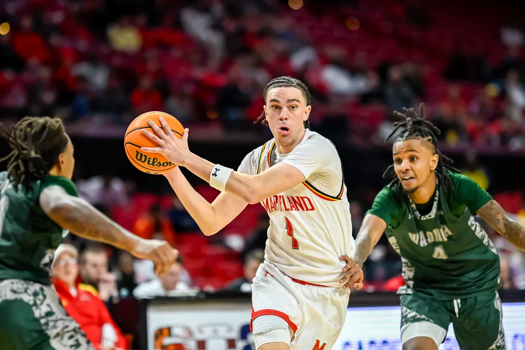 Dec 2, 2025; College Park, Maryland, USA; Maryland Terrapins guard Darius Adams (1) makes a move to the basket on Wagner Seahawks guard John Awoke (4) during the second half at Xfinity Center. Mandatory Credit: Tommy Gilligan-Imagn Images
