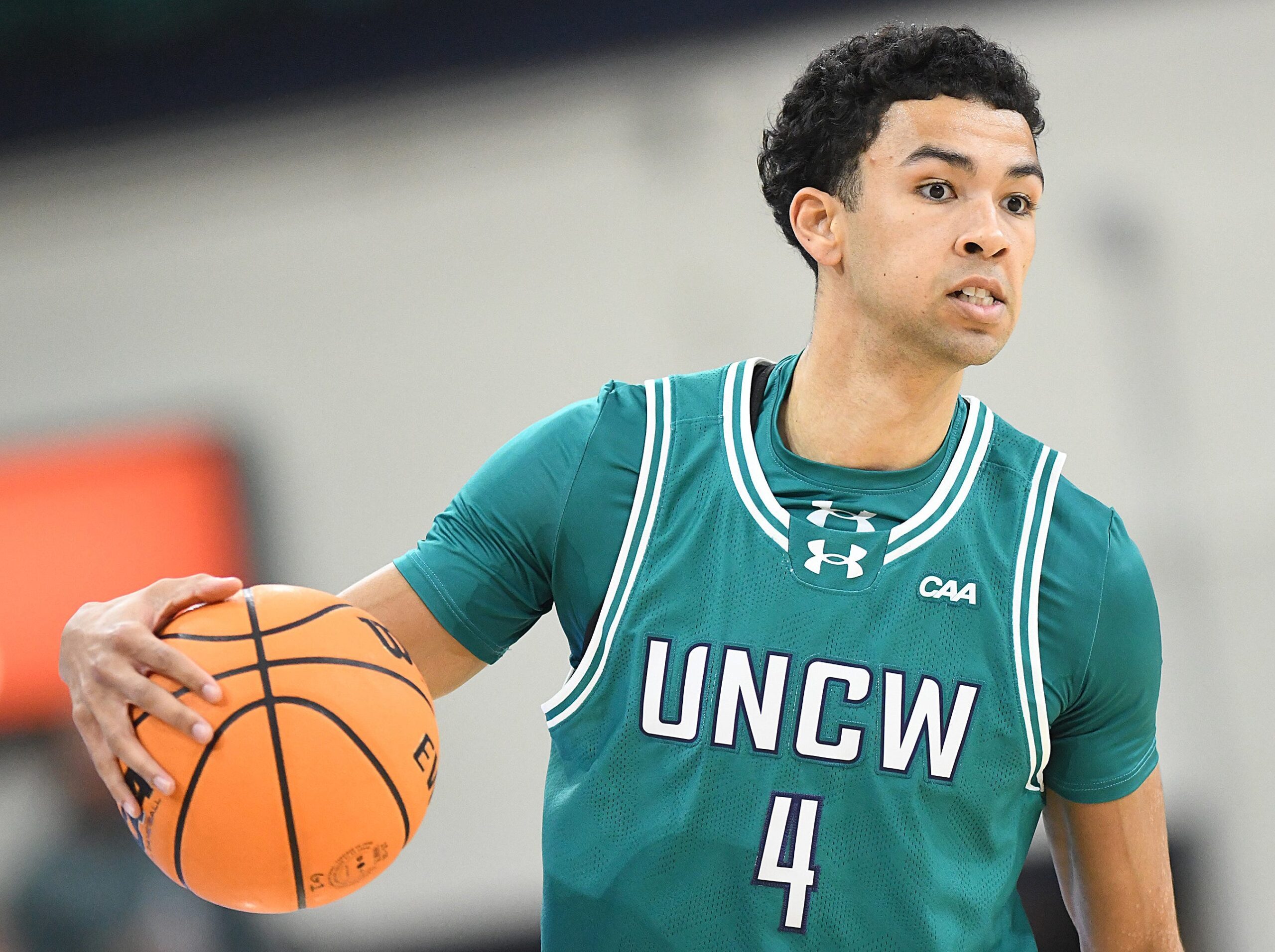 UNCW's #4 Nolan Hodge looks to pass off the ball as UNCW played Marshall.