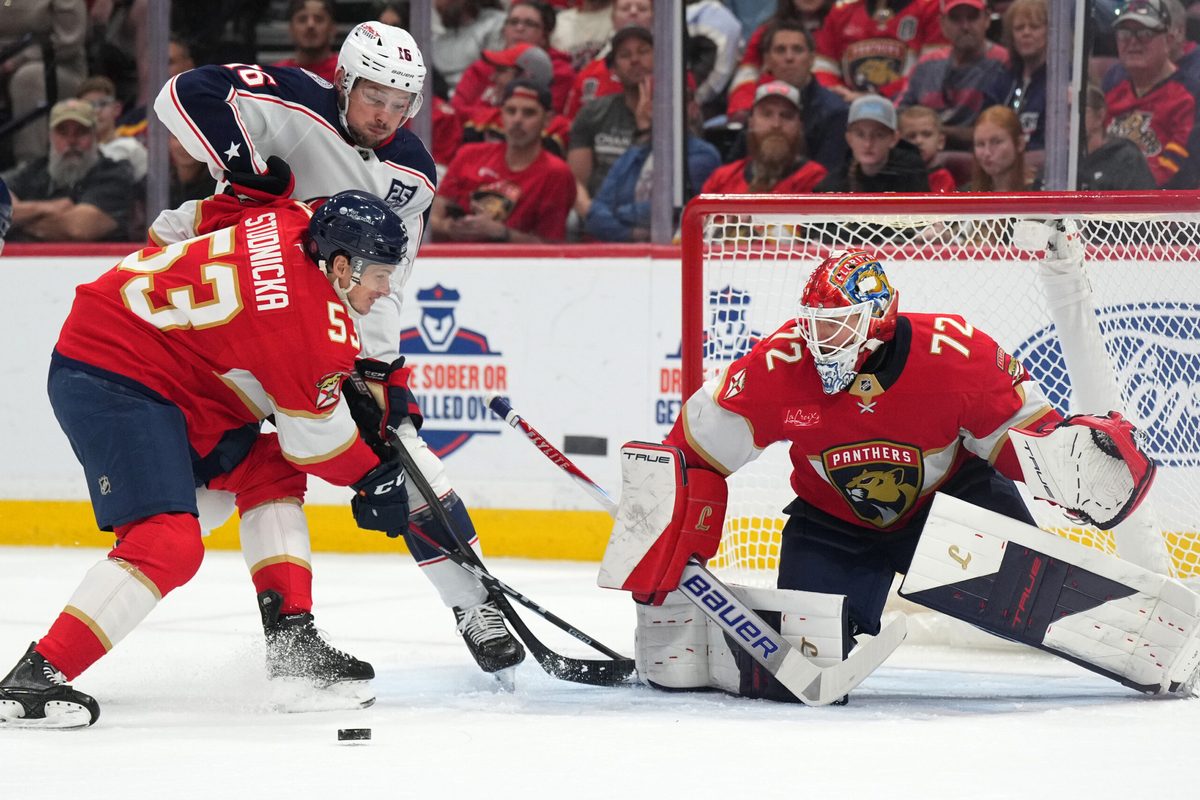 Dec 6, 2025; Sunrise, Florida, USA;  Florida Panthers center Jack Studnicka (53) defends Columbus Blue Jackets center Brendan Gaunce (16) as the puck goes toward the net during the first period at Amerant Bank Arena. Mandatory Credit: Jim Rassol-Imagn Images