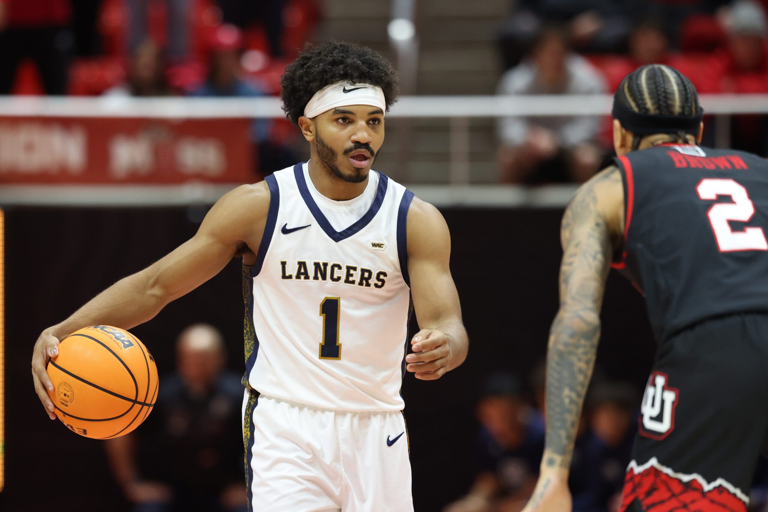 Dec 6, 2025; Salt Lake City, Utah, USA; California Baptist Lancers guard Dominique Daniels Jr. (1) brings the ball up the court against Utah Utes guard Terrence Brown (2) during the first half at Jon M. Huntsman Center. Mandatory Credit: Rob Gray-Imagn Images