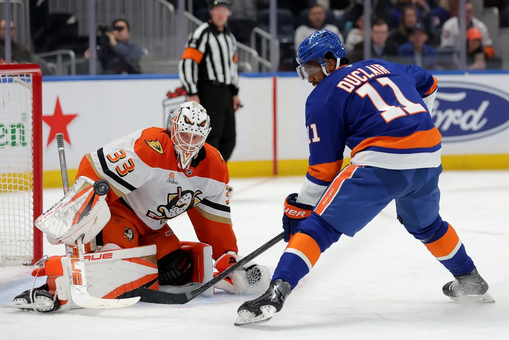 Dec 11, 2025; Elmont, New York, USA; Anaheim Ducks goaltender Ville Husso (33) makes a save against New York Islanders left wing Anthony Duclair (11) during the second period at UBS Arena. Mandatory Credit: Brad Penner-Imagn Images