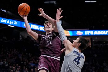Dec 12, 2025; Cincinnati, Ohio, USA;  Missouri State Bears forward Keith Palek III (11) drives to the basket against Xavier Musketeers forward Filip Borovicanin (4) in the second half at the Cintas Center. Mandatory Credit: Aaron Doster-Imagn Images