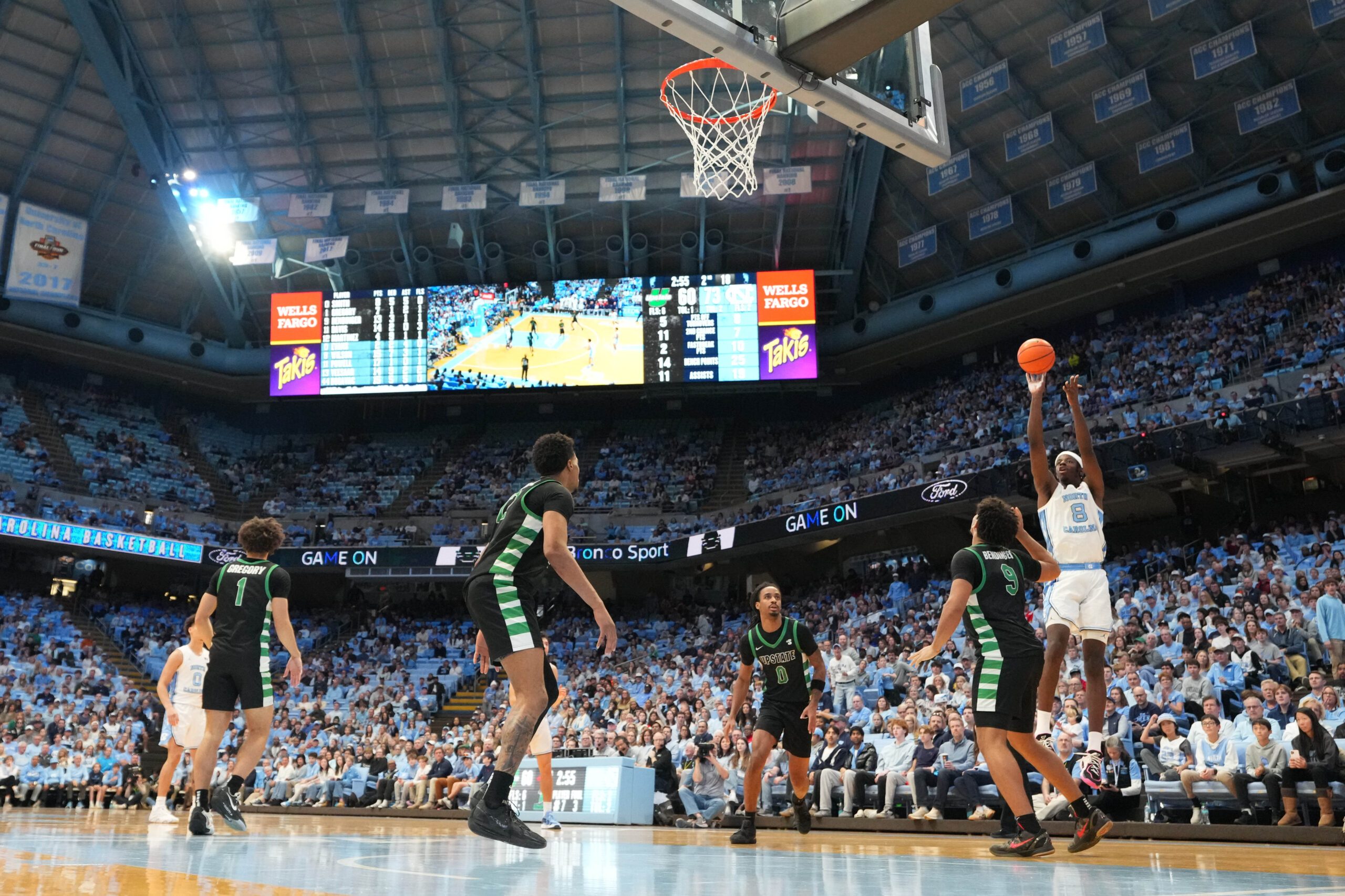Dec 13, 2025; Chapel Hill, North Carolina, USA; North Carolina Tar Heels forward Caleb Wilson (8) shoots as USC Upstate Spartans guard Mason Bendinger (9) defends in the second half at Dean E. Smith Center. Mandatory Credit: Bob Donnan-Imagn Images