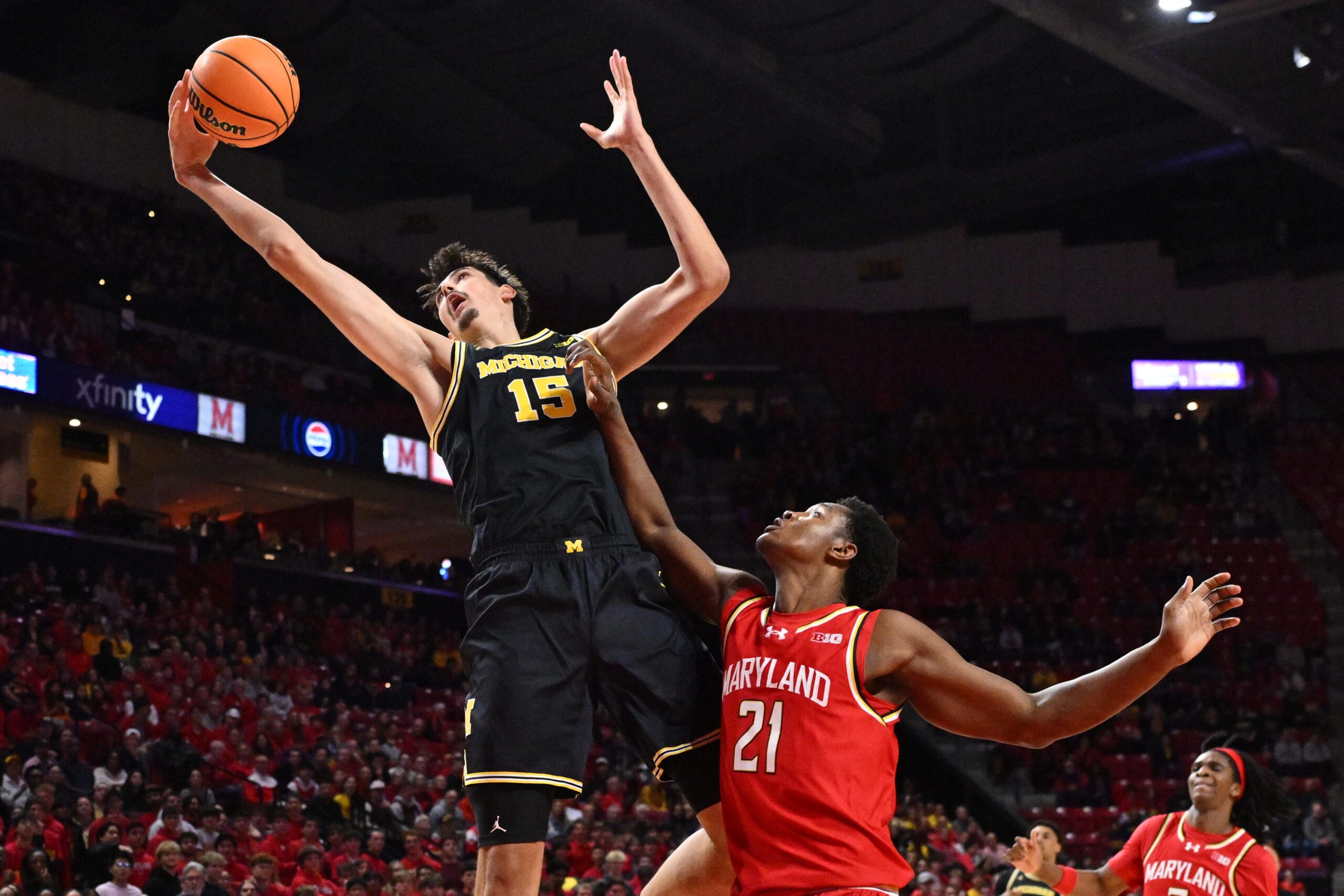 Dec 13, 2025; College Park, Maryland, USA;  Michigan Wolverines center Aday Mara (15) reaches for a rebound in the first half over Maryland Terrapins forward Pharrel Payne (21) at Xfinity Center. Mandatory Credit: Jamie Sabau-Imagn Images