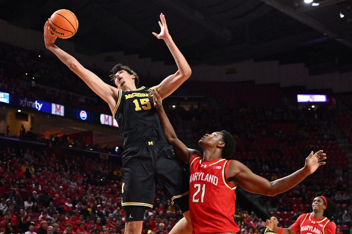 Dec 13, 2025; College Park, Maryland, USA; Michigan Wolverines center Aday Mara (15) reaches for a rebound in the first half over Maryland Terrapins forward Pharrel Payne (21) at Xfinity Center. Mandatory Credit: Jamie Sabau-Imagn Images