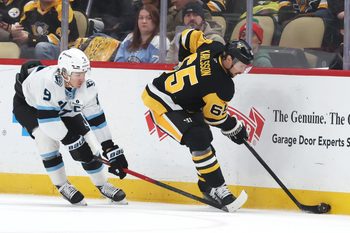 Dec 14, 2025; Pittsburgh, Pennsylvania, USA;  Pittsburgh Penguins defenseman Erik Karlsson (65) moves the puck against Utah Mammoth right wing Clayton Keller (9) during the third period at PPG Paints Arena. Mandatory Credit: Charles LeClaire-Imagn Images