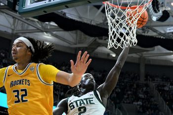 Dec 16, 2025; East Lansing, Michigan, USA; Michigan State Spartans guard Kur Teng (2) slashes in for a basket behind Toledo Rockets forward Jaylan Ouwinga (32) during the second half at Jack Breslin Student Events Center. Mandatory Credit: Dale Young-Imagn Images