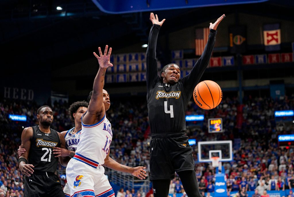 Dec 16, 2025; Lawrence, Kansas, USA; Kansas Jayhawks guard Elmarko Jackson (13) knocks the ball away from Towson Tigers guard Dylan Williamson (4) during the first half at Allen Fieldhouse. Mandatory Credit: Jay Biggerstaff-Imagn Images