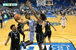 Dec 19, 2025; Los Angeles, California, USA; UCLA Bruins guard Donovan Dent (2) scores a basket over Cal Poly Mustangs guard Hamad Mousa (10) during the second half at Pauley Pavilion presented by Wescom Financial. Mandatory Credit: Jayne Kamin-Oncea-Imagn Images