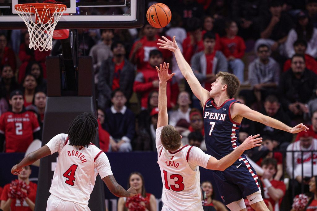 Dec 20, 2025; Piscataway, New Jersey, USA; Penn Quakers guard Michael Zanoni (7) scores a basket against Rutgers Scarlet Knights guard Harun Zrno (13) during the second half at Jersey Mike's Arena. Mandatory Credit: Vincent Carchietta-Imagn Images