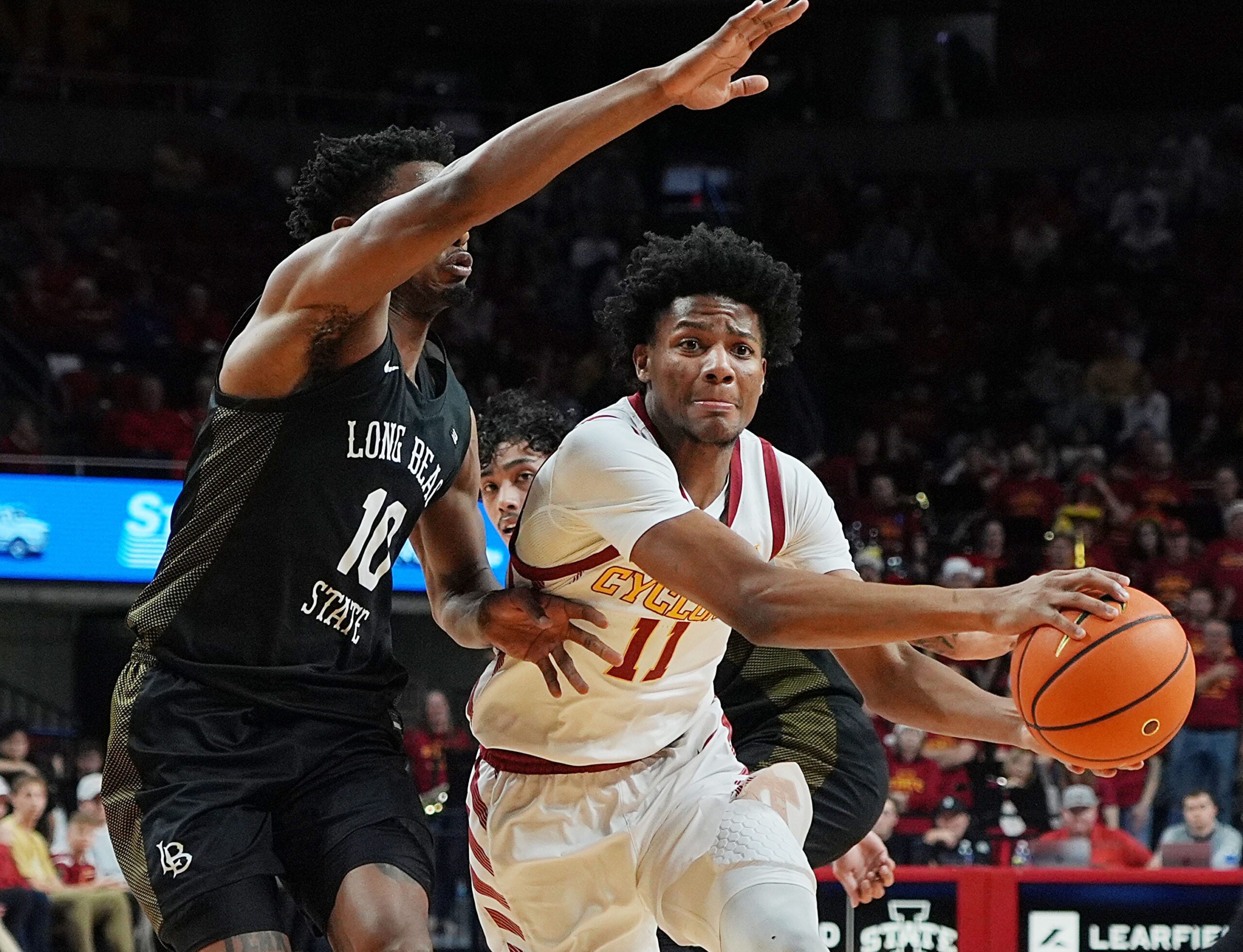 Iowa State Cyclones guard Dominick Nelson (11) drives with the ball around Long Beach State guard Cole Farrell (10) during the second half in the NCAA men’s basketball on Dec. 21, 2025, at Hilton Coliseum in Ames, Iowa.