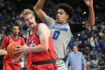 Dec 22, 2025; Omaha, Nebraska, USA;  Utah Tech Trailblazers forward Ethan Potter (35) drives against Creighton Bluejays forward Jasen Green (0) during the first half at CHI Health Center Omaha. Mandatory Credit: Steven Branscombe-Imagn Images