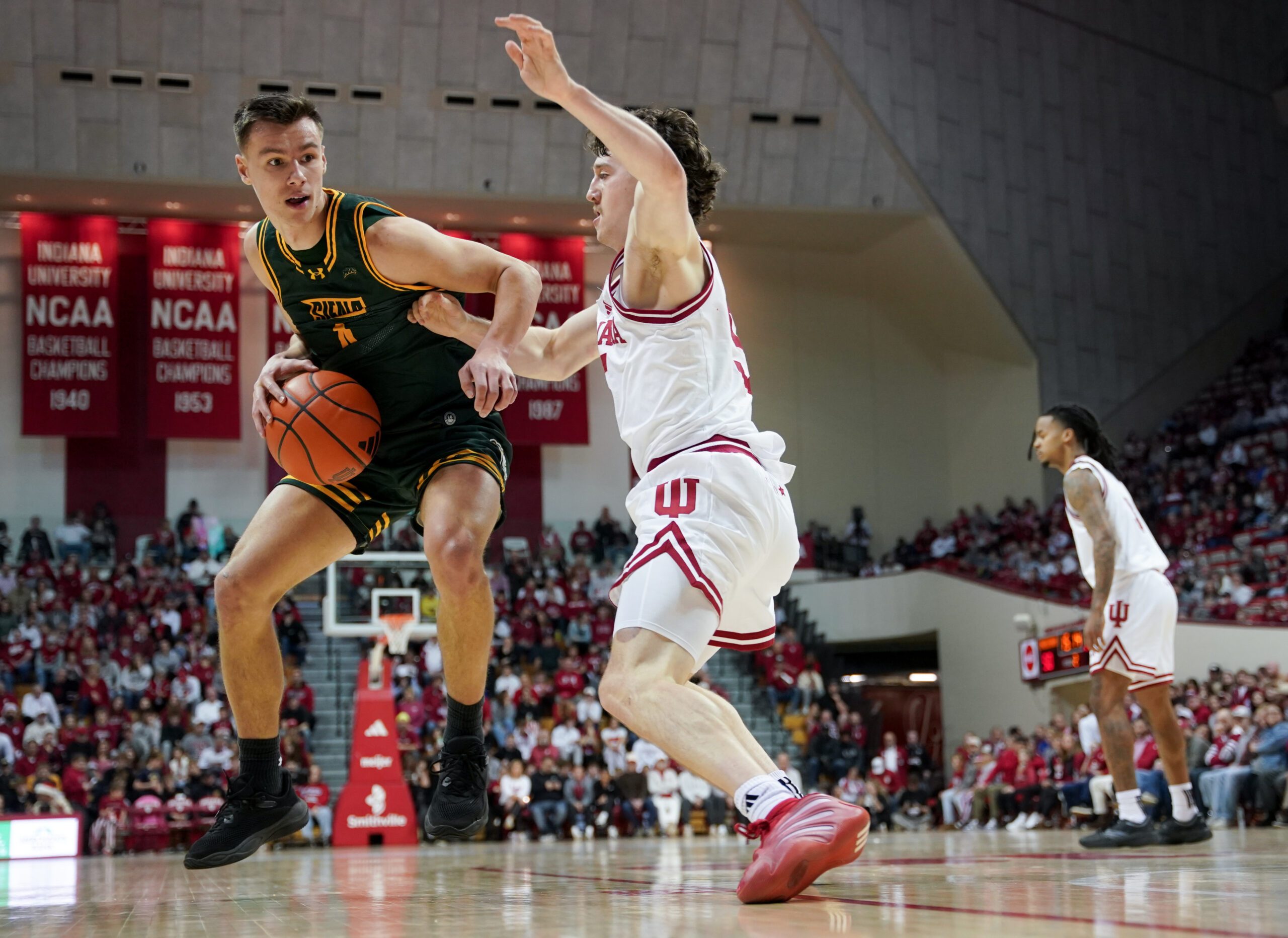 Dec 22, 2025; Bloomington, Indiana, USA; Siena Saints guard Gavin Doty (4) goes to the basket against Indiana Hoosiers guard Conor Enright (5) during the second half at Simon Skjodt Assembly Hall. Mandatory Credit: Robert Goddin-Imagn Images