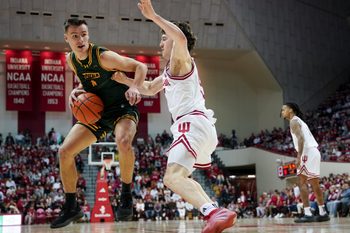 Dec 22, 2025; Bloomington, Indiana, USA; Siena Saints guard Gavin Doty (4) goes to the basket against Indiana Hoosiers guard Conor Enright (5) during the second half at Simon Skjodt Assembly Hall. Mandatory Credit: Robert Goddin-Imagn Images