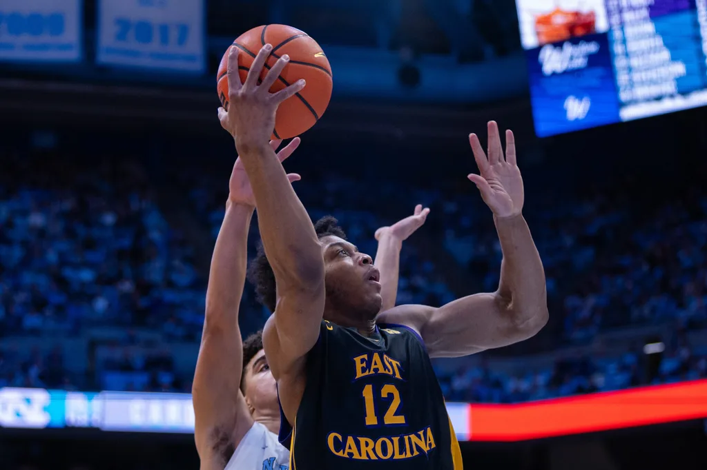 Dec 22, 2025; Chapel Hill, North Carolina, USA; East Carolina Pirates guard Jordan Riley (12) shoots against the North Carolina Tar Heels during the first half at Dean E. Smith Center. Mandatory Credit: Scott Kinser-Imagn Images