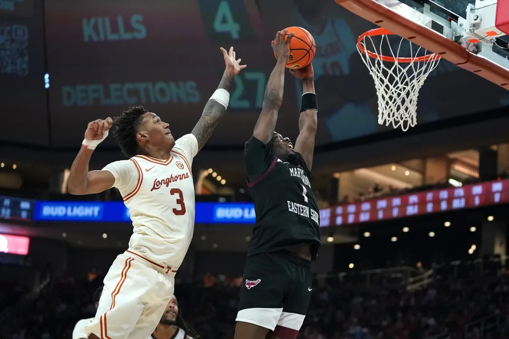 Dec 22, 2025; Austin, Texas, USA;Maryland Eastern Shore Hawks guard Zion Obanla (1) dunks the ball against Texas Longhorns guard Dailyn Swain (3) during the second half at Moody Center. Mandatory Credit: Dustin Safranek-Imagn Images