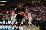 Dec 28, 2025; Lubbock, Texas, USA;  Winthrop Eagles center Logan Duncomb (51) holds the ball against Texas Tech Red Raiders forward JT Toppin (15) in the second half at United Supermarkets Arena. Mandatory Credit: Michael C. Johnson-Imagn Images