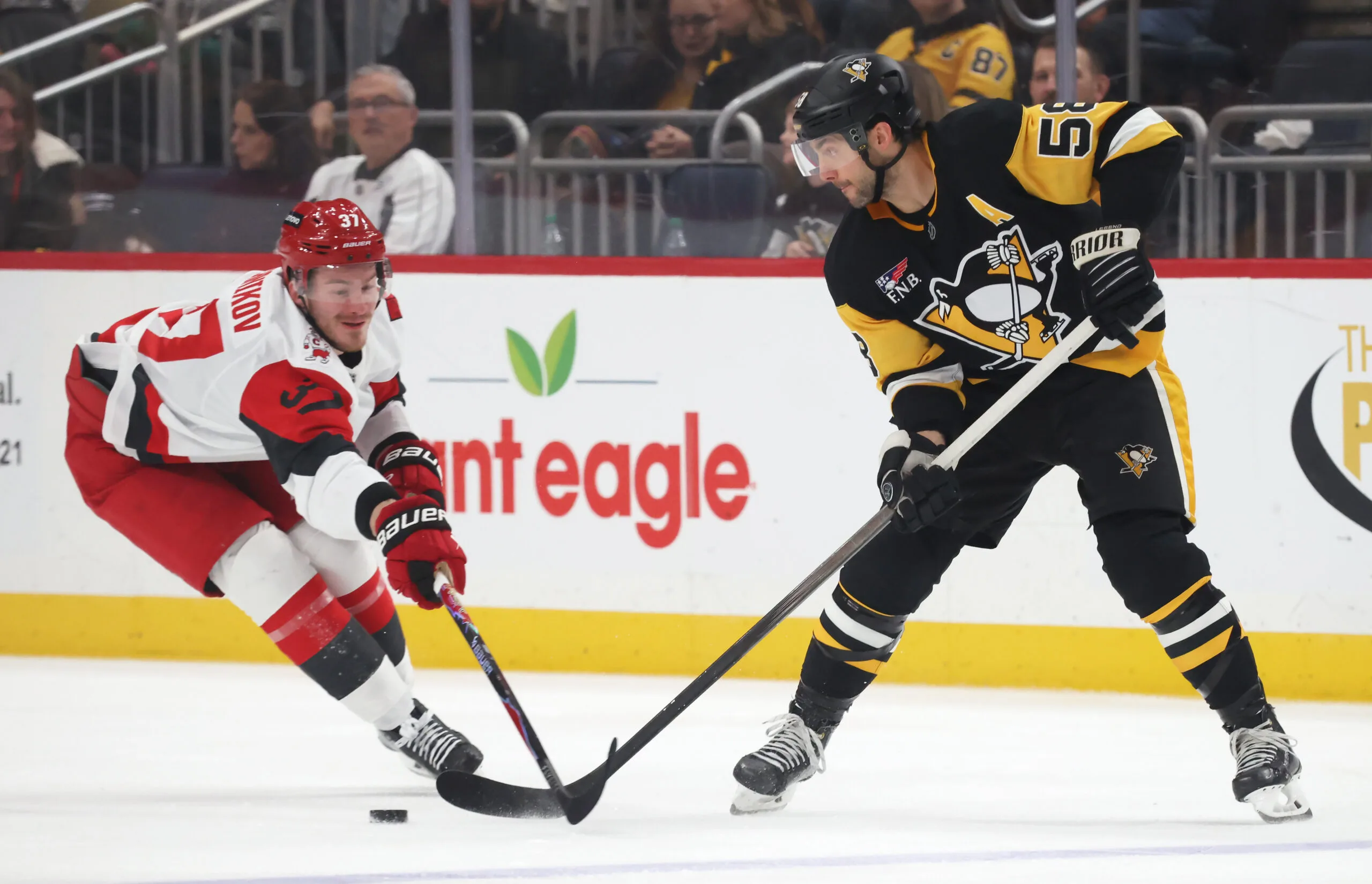 Dec 30, 2025; Pittsburgh, Pennsylvania, USA; Pittsburgh Penguins defenseman Kris Letang (58) passes the puck against Carolina Hurricanes right wing Andrei Svechnikov (37) during the second period at PPG Paints Arena. Mandatory Credit: Charles LeClaire-Imagn Images