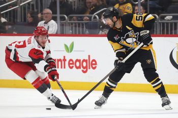 Dec 30, 2025; Pittsburgh, Pennsylvania, USA; Pittsburgh Penguins defenseman Kris Letang (58) passes the puck against Carolina Hurricanes right wing Andrei Svechnikov (37) during the second period at PPG Paints Arena. Mandatory Credit: Charles LeClaire-Imagn Images