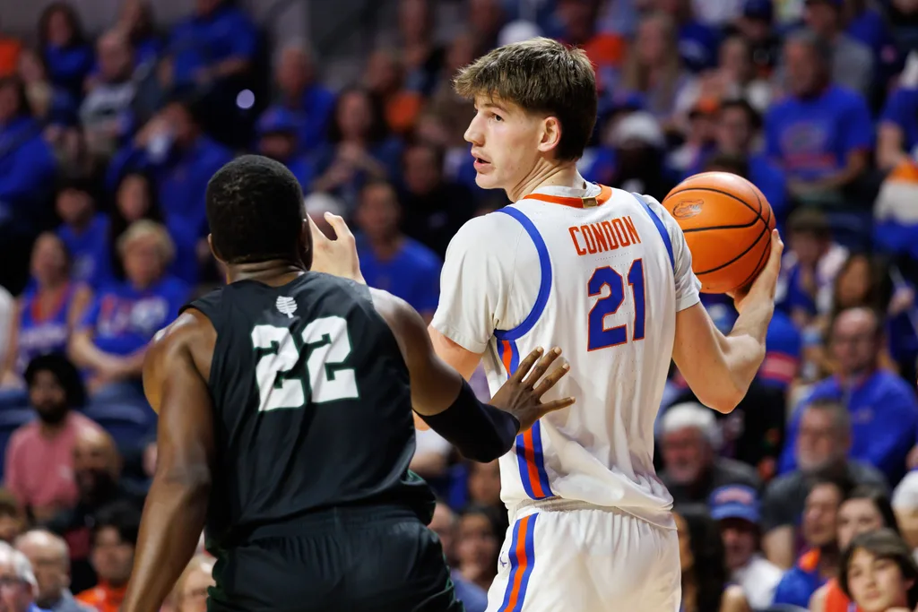 Dec 29, 2025; Gainesville, Florida, USA; Florida Gators forward Alex Condon (21) posts up against Dartmouth Big Green forward Jayden Williams (22) during the second half at Exactech Arena at the Stephen C. O'Connell Center. Mandatory Credit: Matt Pendleton-Imagn Images