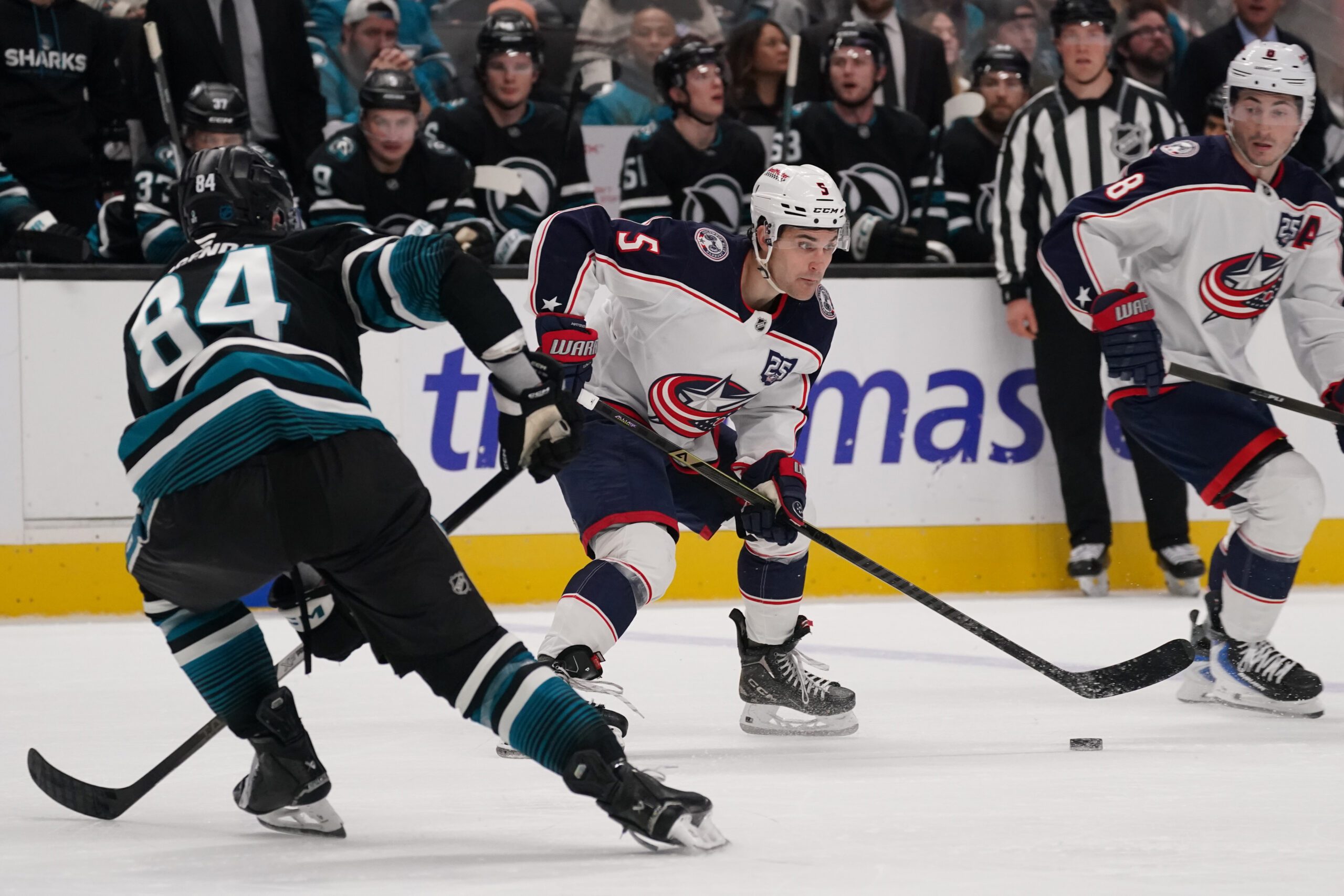 Jan 6, 2026; San Jose, California, USA;  Columbus Blue Jackets defenseman Denton Mateychuk (5) looks to pass against San Jose Sharks left wing Pavol Regenda (84) in the third period at SAP Center at San Jose. Mandatory Credit: David Gonzales-Imagn Images