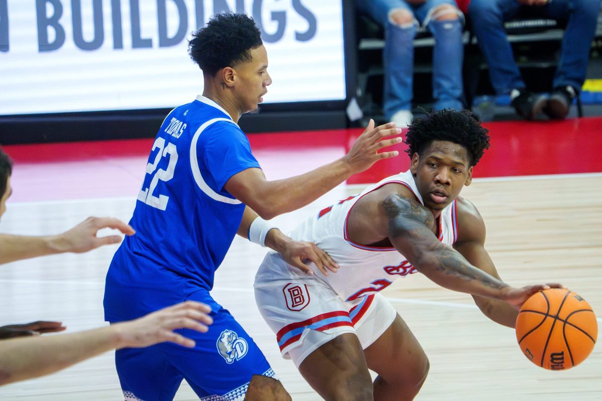 Bradley’s Jaquan Johnson, far right, passes the ball around Drake’s Jaehshon in the first half of their college basketball game Wednesday, Jan. 7, 2026 at Carver Arena in Peoria. The Braves defeated the Bulldogs 93-66.