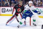 Jan 13, 2026; Ottawa, Ontario, CAN; Ottawa Senators goalie Leevi Merilainen (1) and Vancouver Canucks center Aatu Raty (54) follow the puck in the second period at the Canadian Tire Centre. Mandatory Credit: Marc DesRosiers-IMAGN Images