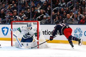 Jan 15, 2026; Columbus, Ohio, USA; Vancouver Canucks goalie Kevin Lankinen (32) makes a save on the shot attempt of Columbus Blue Jackets center Adam Fantilli (19) during the third period at Nationwide Arena. Mandatory Credit: Russell LaBounty-Imagn Images