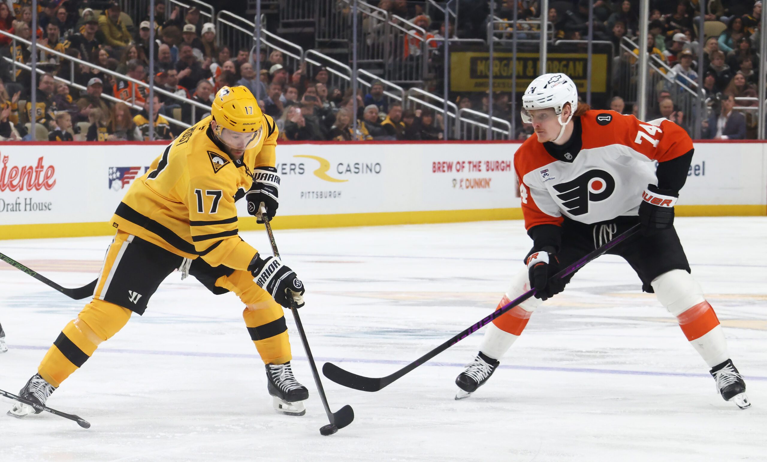 Jan 15, 2026; Pittsburgh, Pennsylvania, USA;  Pittsburgh Penguins right wing Bryan Rust (17) moves the puck against Philadelphia Flyers right wing Owen Tippett (74) during the third period at PPG Paints Arena. Mandatory Credit: Charles LeClaire-Imagn Images