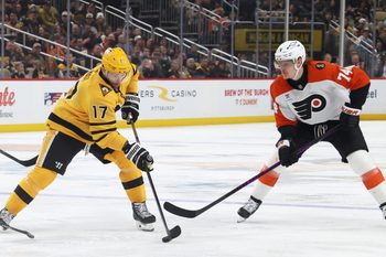Jan 15, 2026; Pittsburgh, Pennsylvania, USA;  Pittsburgh Penguins right wing Bryan Rust (17) moves the puck against Philadelphia Flyers right wing Owen Tippett (74) during the third period at PPG Paints Arena. Mandatory Credit: Charles LeClaire-Imagn Images