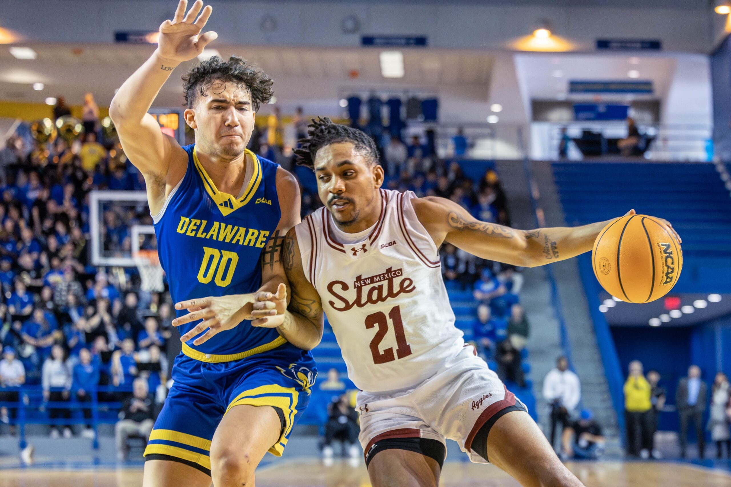 Delaware Hens guard Christian Bliss (00) defends against New Mexico State Aggies guard Jemel Jones (21) during the game on Jan. 17, 2026, at The Bob Carpenter Center.
