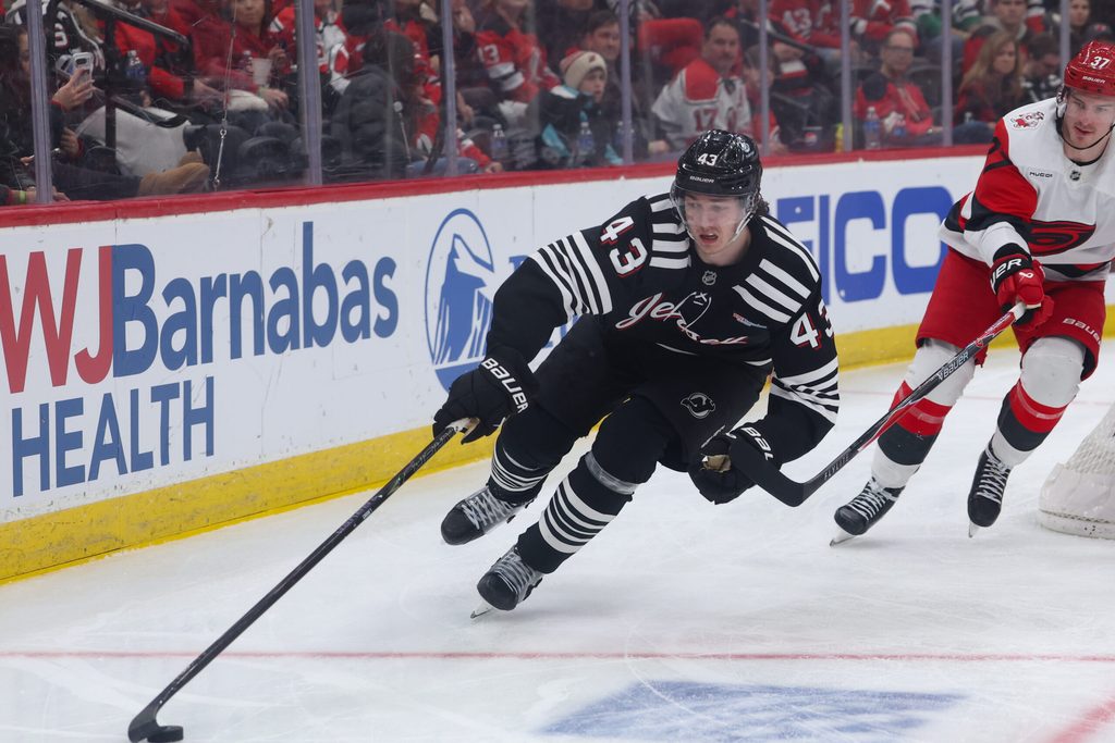 Jan 17, 2026; Newark, New Jersey, USA; New Jersey Devils defenseman Luke Hughes (43) skates with the puck against the Carolina Hurricanes during the third period at Prudential Center. Mandatory Credit: Thomas Salus-Imagn Images