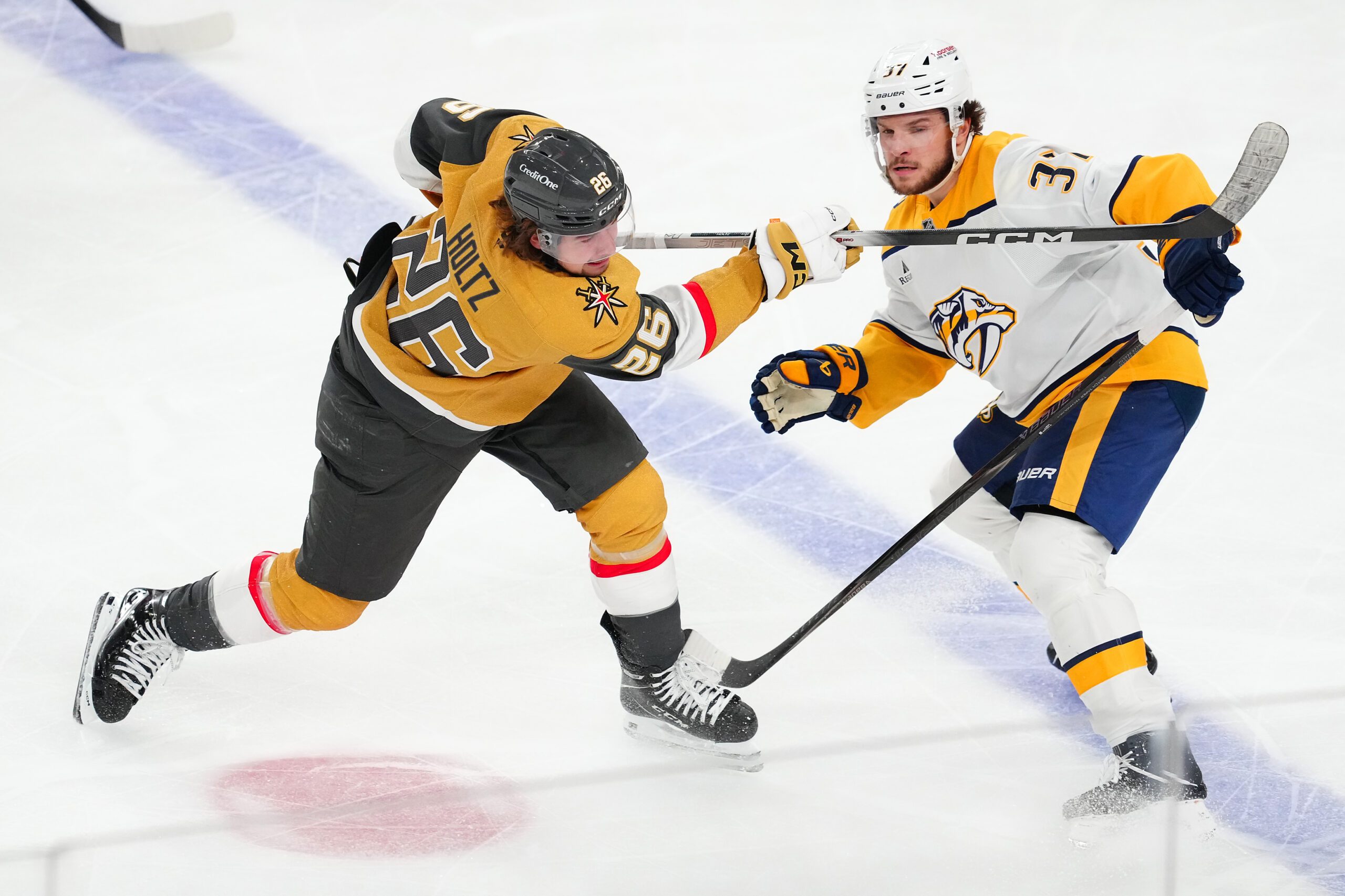 Jan 17, 2026; Las Vegas, Nevada, USA; Vegas Golden Knights right wing Alexander Holtz (26) shoots the puck in front of Nashville Predators defenseman Nick Blankenburg (37) during the third period at T-Mobile Arena. Mandatory Credit: Stephen R. Sylvanie-Imagn Images