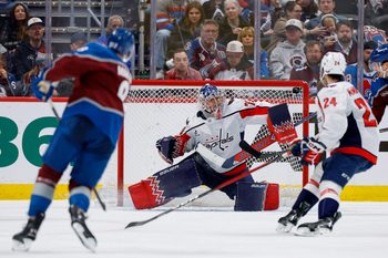 Jan 19, 2026; Denver, Colorado, USA; Washington Capitals goaltender Charlie Lindgren (79) watches a shot from Colorado Avalanche defenseman Cale Makar (8) as center Connor McMichael (24) defends in the third period at Ball Arena. Mandatory Credit: Isaiah J. Downing-Imagn Images
