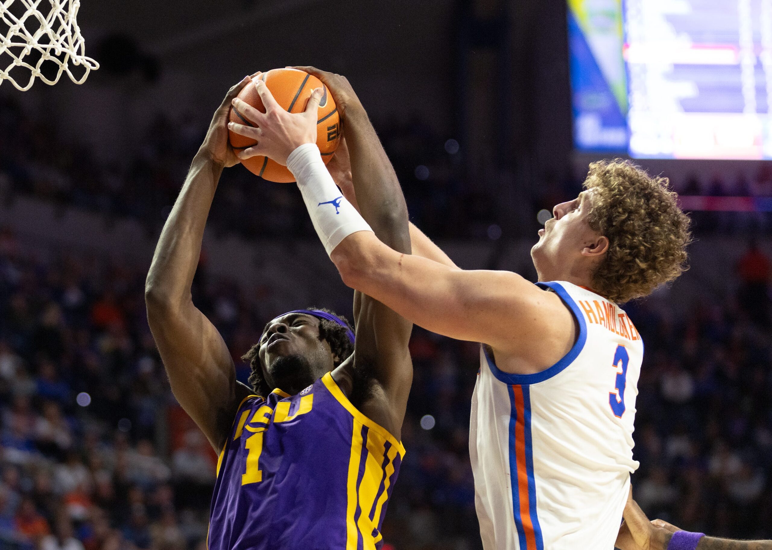 LSU center Michael Nwoko (1) and Florida center Micah Handlogten (3) fight for the rebound during the first half of an NCAA mens basketball game at Steven C. O'Connell Center Exactek arena in Gainesville, FL on Tuesday, January 20, 2026. [Alan Youngblood/Gainesville Sun]