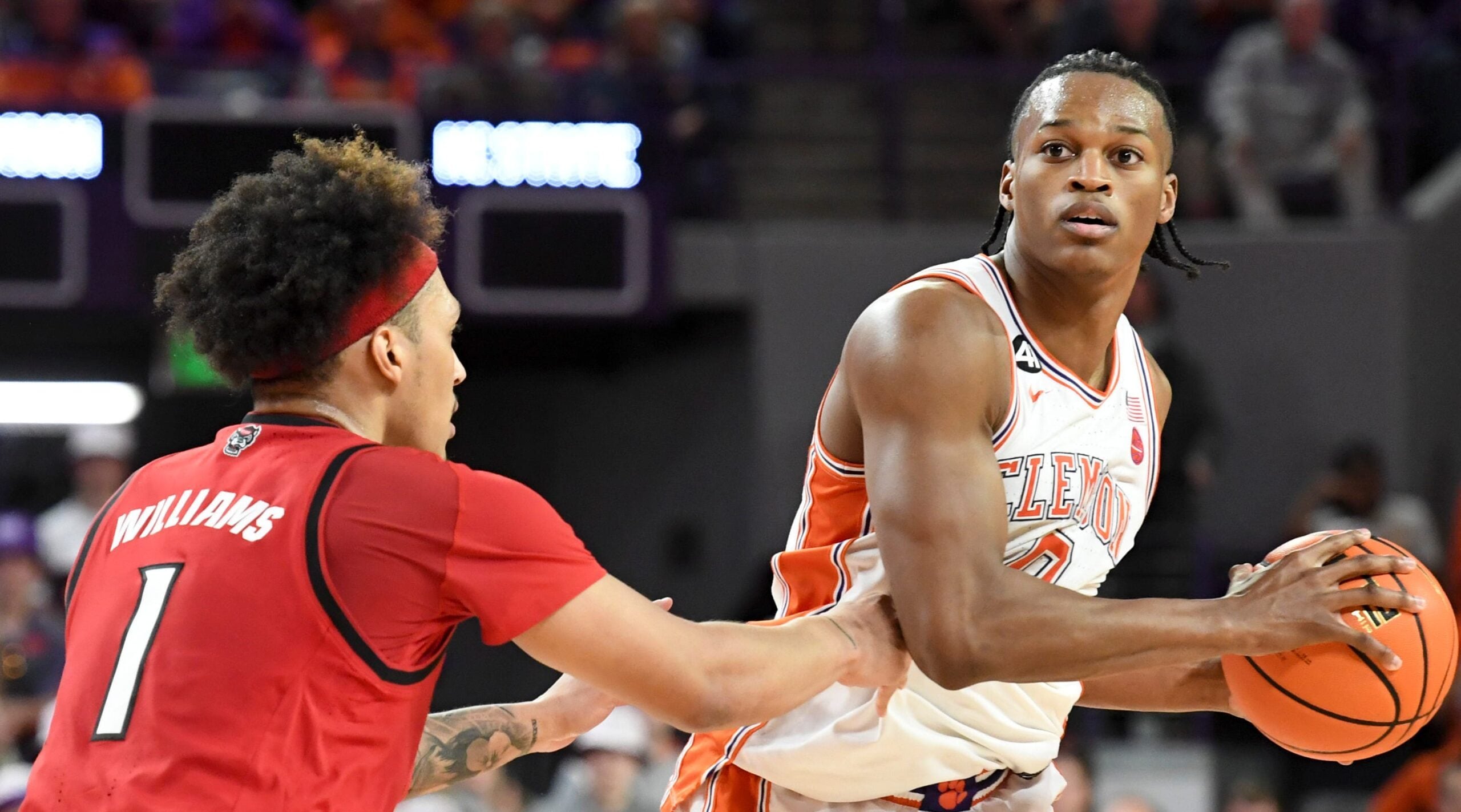 NC State Wolfpack forward Darrion Williams (1) defends Clemson Tigers forward RJ Godfrey (0) Tuesday, Jan. 20, 2026, during the NCAA men’s basketball game at Littlejohn Coliseum in Clemson, South Carolina. NC State Wolfpack won 80-76 in OT.