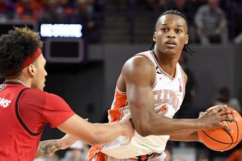 NC State Wolfpack forward Darrion Williams (1) defends Clemson Tigers forward RJ Godfrey (0) Tuesday, Jan. 20, 2026, during the NCAA men’s basketball game at Littlejohn Coliseum in Clemson, South Carolina. NC State Wolfpack won 80-76 in OT.