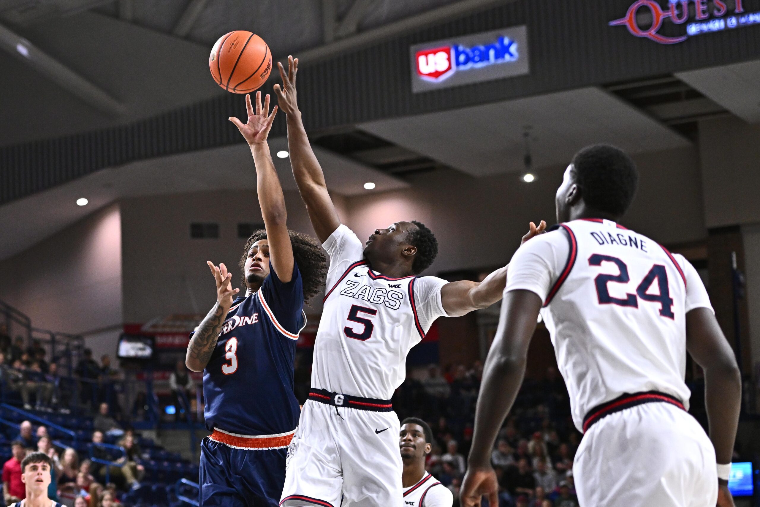 Jan 21, 2026; Spokane, Washington, USA; Pepperdine Waves guard Aaron Clark (3) shoots the ball against Gonzaga Bulldogs forward Emmanuel Innocenti (5) in the second half at McCarthey Athletic Center. Mandatory Credit: James Snook-Imagn Images