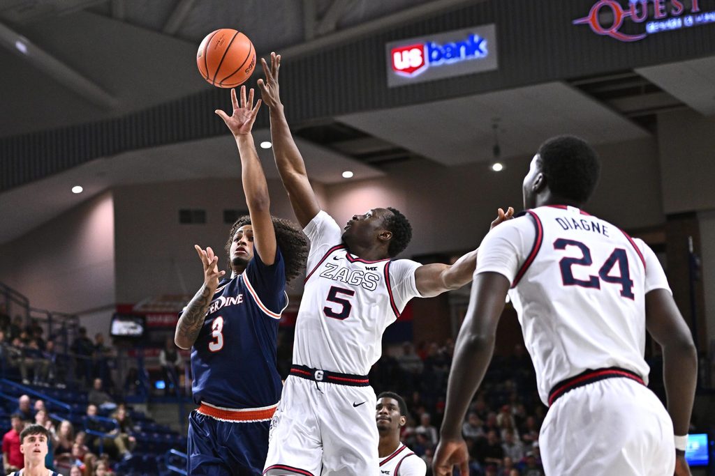 Jan 21, 2026; Spokane, Washington, USA; Pepperdine Waves guard Aaron Clark (3) shoots the ball against Gonzaga Bulldogs forward Emmanuel Innocenti (5) in the second half at McCarthey Athletic Center. Mandatory Credit: James Snook-Imagn Images
