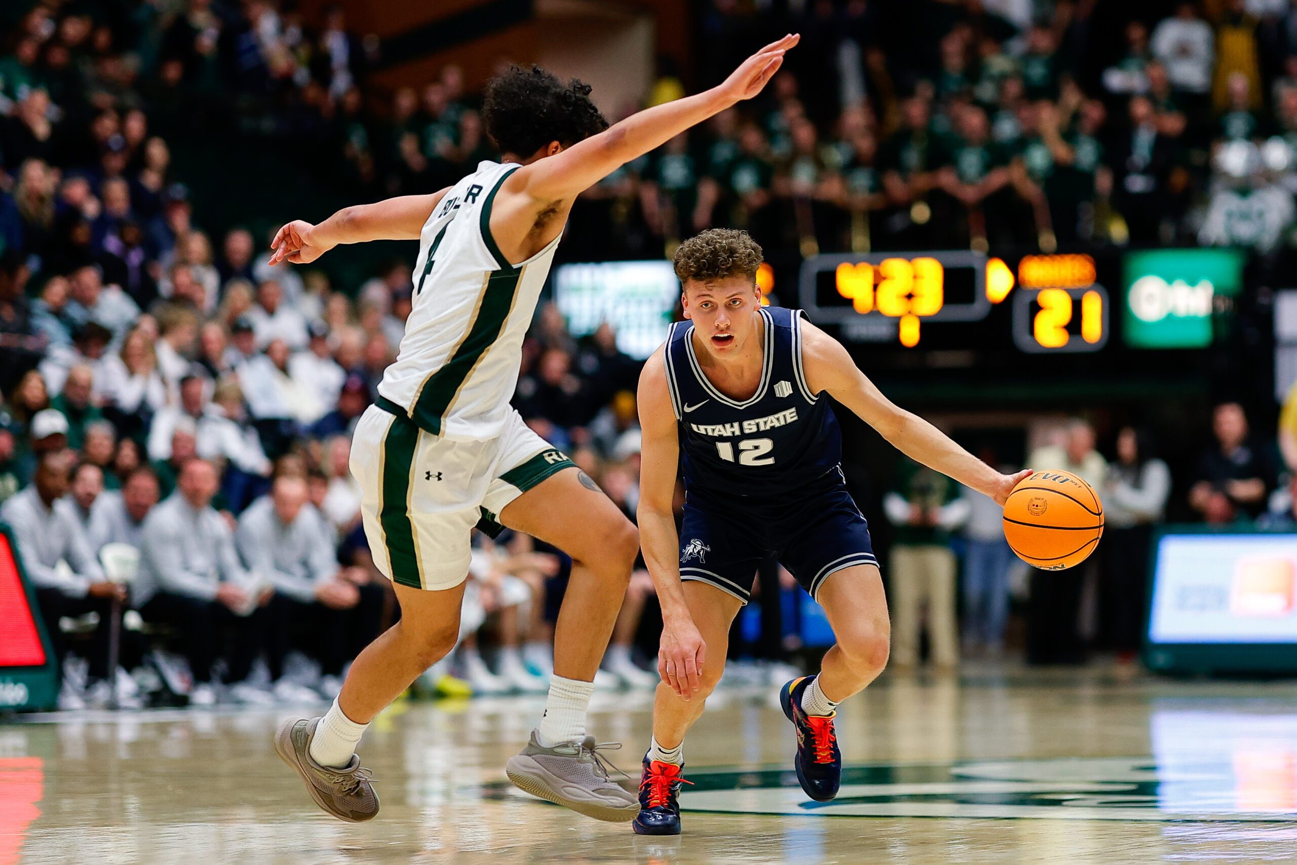 Jan 23, 2026; Fort Collins, Colorado, USA; Utah State Aggies guard Mason Falslev (12) controls the ball as Colorado State Rams guard Jase Butler (4) guards in the first half at Moby Arena. Mandatory Credit: Isaiah J. Downing-Imagn Images