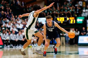 Jan 23, 2026; Fort Collins, Colorado, USA; Utah State Aggies guard Mason Falslev (12) controls the ball as Colorado State Rams guard Jase Butler (4) guards in the first half at Moby Arena. Mandatory Credit: Isaiah J. Downing-Imagn Images