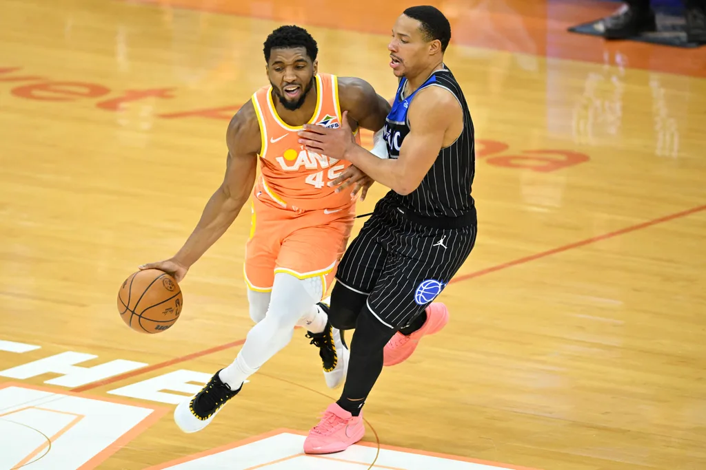 Jan 26, 2026; Cleveland, Ohio, USA; Cleveland Cavaliers guard Donovan Mitchell (45) dribbles beside Orlando Magic guard Desmond Bane (3) in the fourth quarter at Rocket Arena. Mandatory Credit: David Richard-Imagn Images