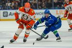 Jan 29, 2026; Vancouver, British Columbia, CAN;  Anaheim Ducks Defenseman Jackson LaCombe (2) chases the puck with Vancouver Canucks left wing Conor Garland (8) in the second period at Rogers Arena. Mandatory Credit: Christopher Morris-Imagn Images