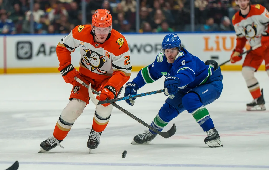 Jan 29, 2026; Vancouver, British Columbia, CAN; Anaheim Ducks Defenseman Jackson LaCombe (2) chases the puck with Vancouver Canucks left wing Conor Garland (8) in the second period at Rogers Arena. Mandatory Credit: Christopher Morris-Imagn Images