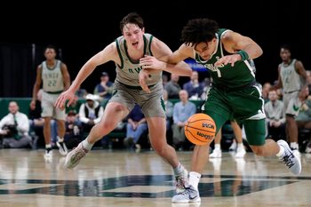University of Wisconsin-Green Bay's Marcus Hall (13) and Cleveland State's Dayan Nessah (7) fight for the ball during a basketball game on Jan. 30, 2026, at the Resch Center in Ashwaubenon, Wis. Cleveland State defeated UW-Green Bay 89-82.
