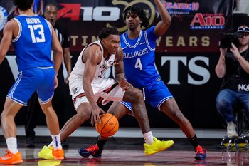 Feb 3, 2026; Davidson, North Carolina, USA; Davidson Wildcats guard Josh Scovens (4) goes to the basket against Saint Louis Billikens guard Amari McCottry (4) during the second half at McKillop Court at John M. Belk Arena. Mandatory Credit: Jim Dedmon-Imagn Images