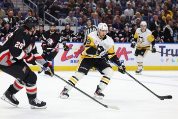 Feb 5, 2026; Buffalo, New York, USA;  Pittsburgh Penguins right wing Egor Chinakhov (59) carries the puck as Buffalo Sabres defenseman Owen Power (25) defends during the third period at KeyBank Center. Mandatory Credit: Timothy T. Ludwig-Imagn Images