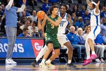 Feb 8, 2026; Memphis, Tennessee, USA; Charlotte 49ers guard Ben Bradford (3) handles the ball against Memphis Tigers forward Aaron Bradshaw (11) during the first half at FedExForum. Mandatory Credit: Wesley Hale-Imagn Images