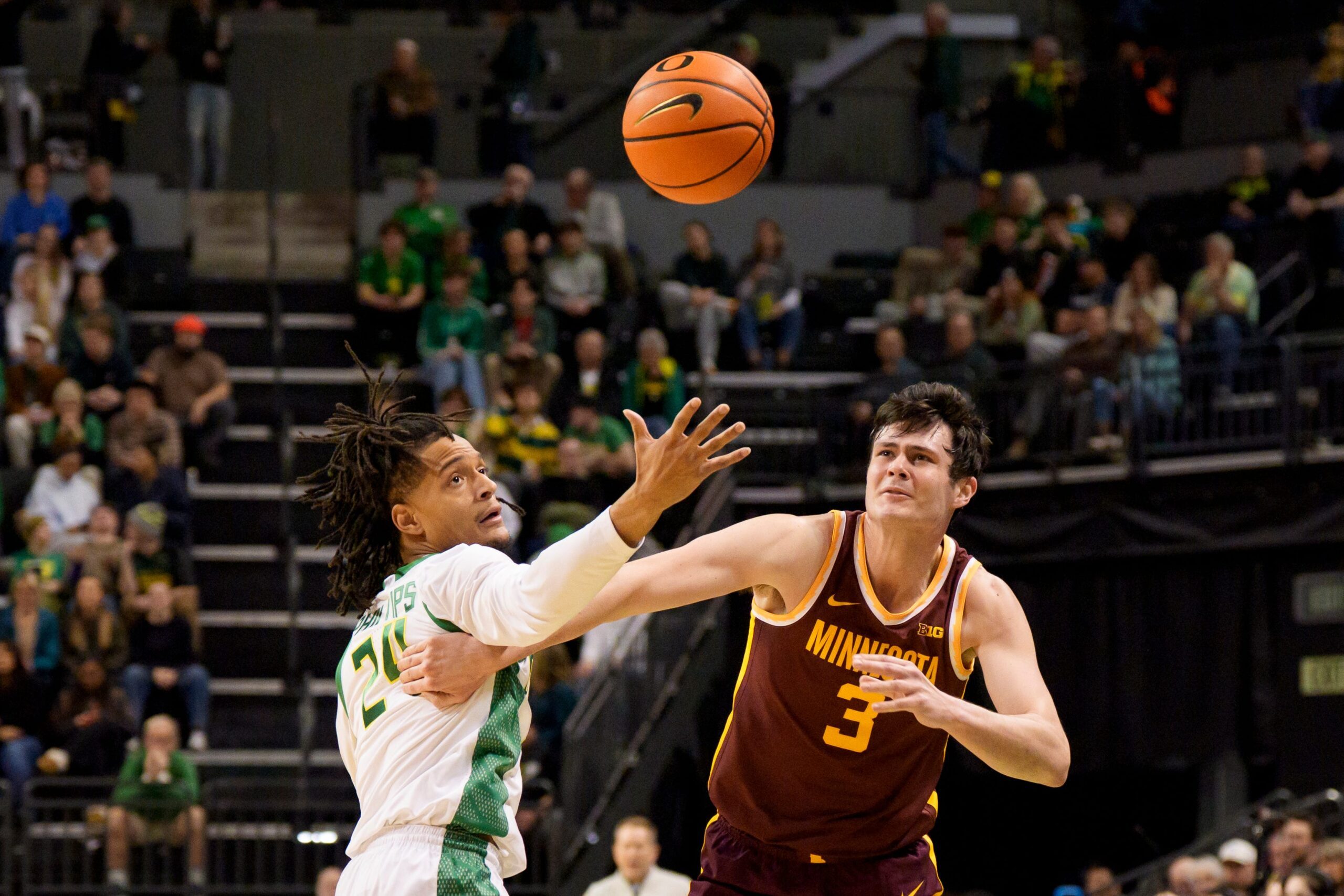 Oregon guard Jamari Phillips, left, is called for a foul as he knocks the ball away from Minnesota forward Bobby Durkin as the Oregon Ducks host the Minnesota Golden Gophers on Feb. 17, 2026, at Matthew Knight Arena in Eugene, Oregon.
