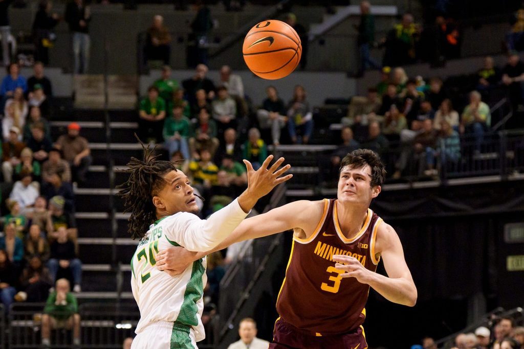 Oregon guard Jamari Phillips, left, is called for a foul as he knocks the ball away from Minnesota forward Bobby Durkin as the Oregon Ducks host the Minnesota Golden Gophers on Feb. 17, 2026, at Matthew Knight Arena in Eugene, Oregon.